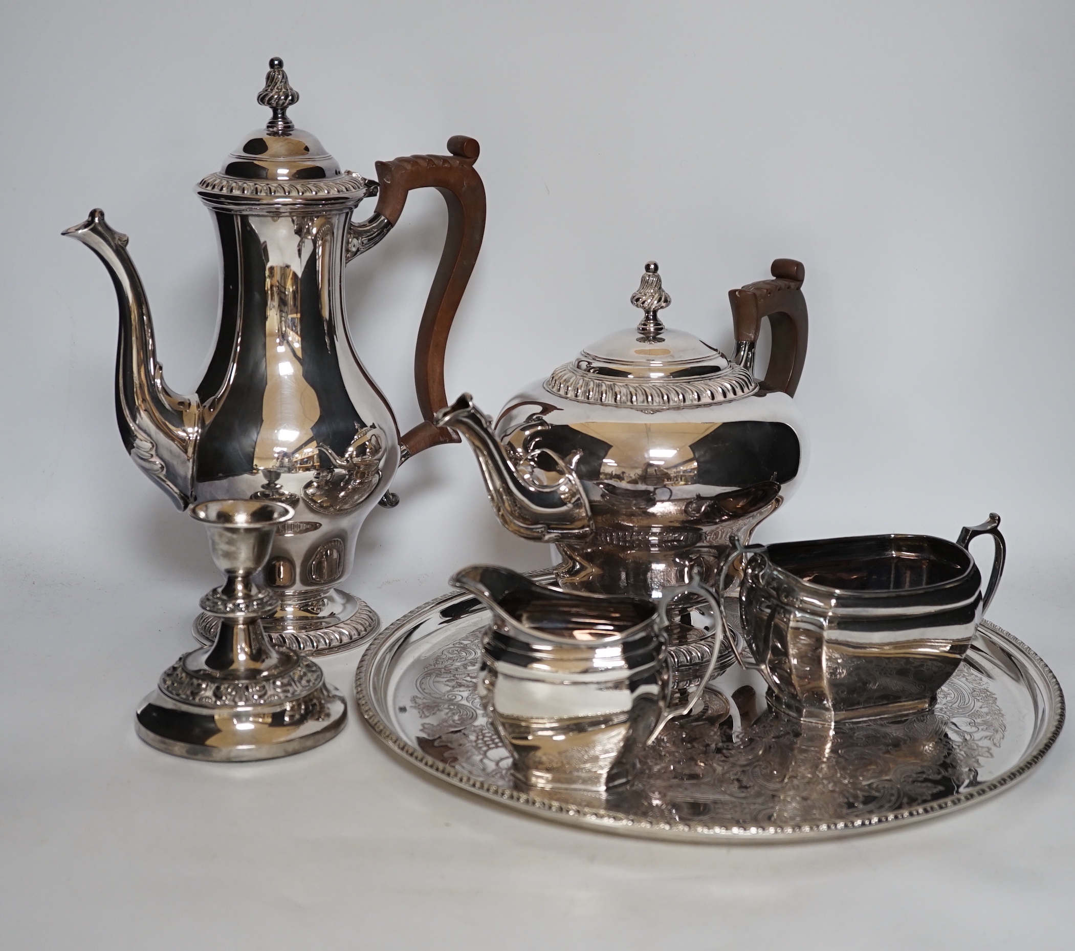 A large quantity of plated wares including a four piece tea and coffee set, other plated wares and cased pan scale